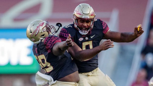 Florida State Seminoles defensive tackle Malcolm Ray (99) and Florida State Seminoles defensive tackle Fabien Lovett (0) celebrate a tackle. The Florida State Seminoles lost to the North Carolina State Wolfpack 14-28 Saturday, Nov. 6, 2021. Fsu V Nc State1262